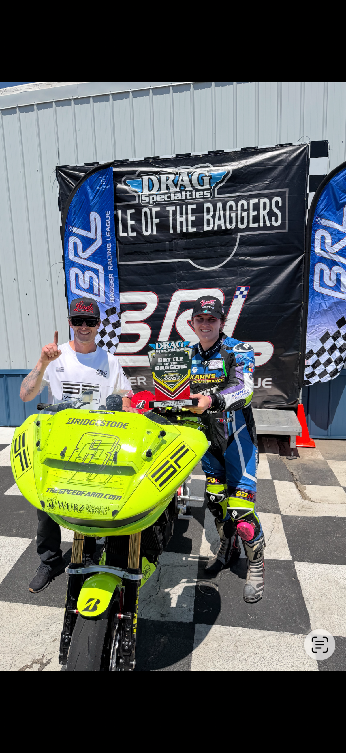 Speed Farm owner Carl Schlacht and racer Levi Badie celebrating a race win with the #8 Harley-Davidson race bagger